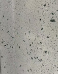 Integrated floor and wall decoration effect: a mixture of white natural marble aggregate and dark grey-green stone terrazzo tiles